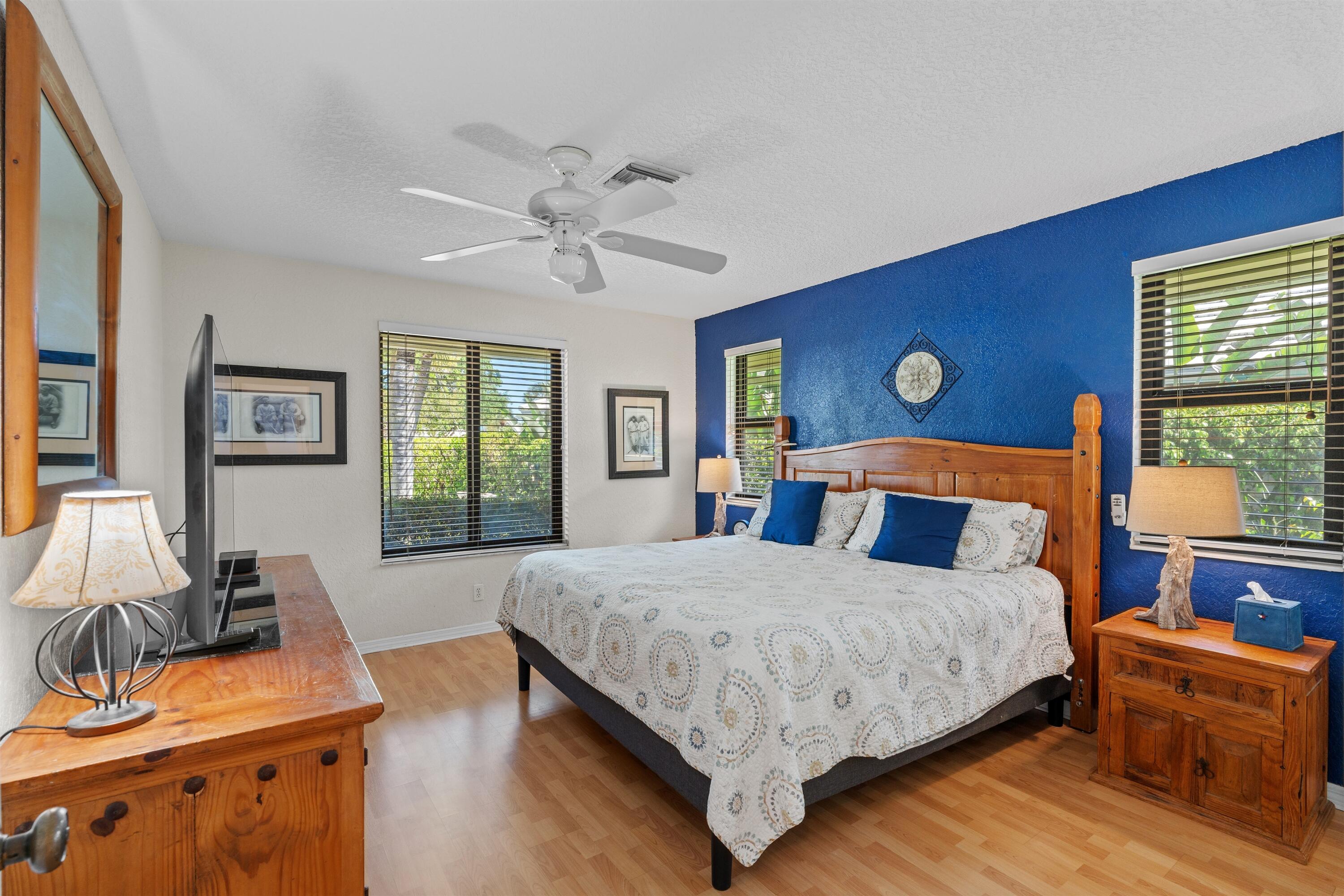 1223 Pepperridge Terrace Boca Raton, FL 33486 - Photo 20 of 34 a bedroom with a bed and wooden floor