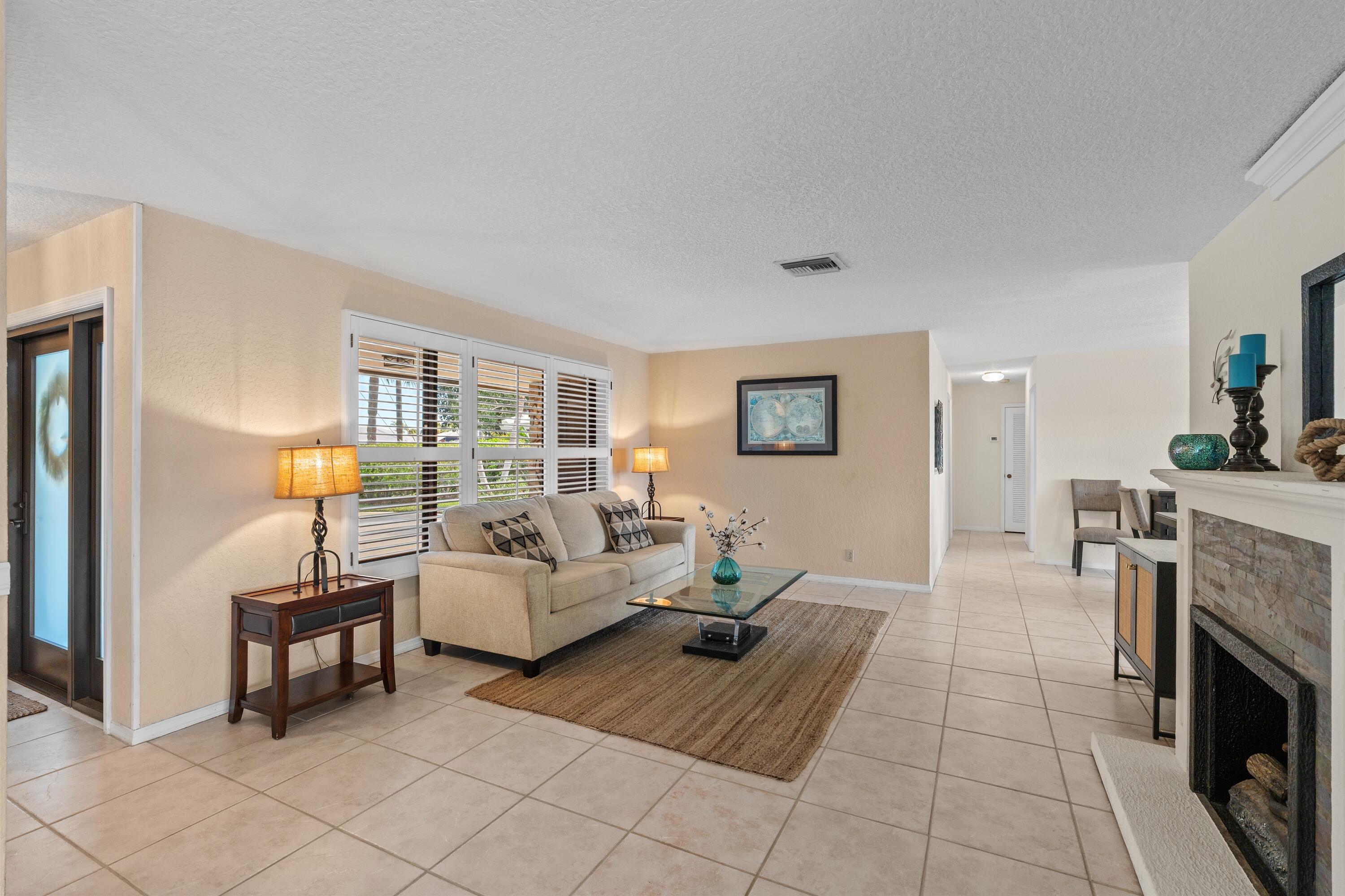 1223 Pepperridge Terrace Boca Raton, FL 33486 - Photo 2 of 34 a living room with furniture and a fireplace