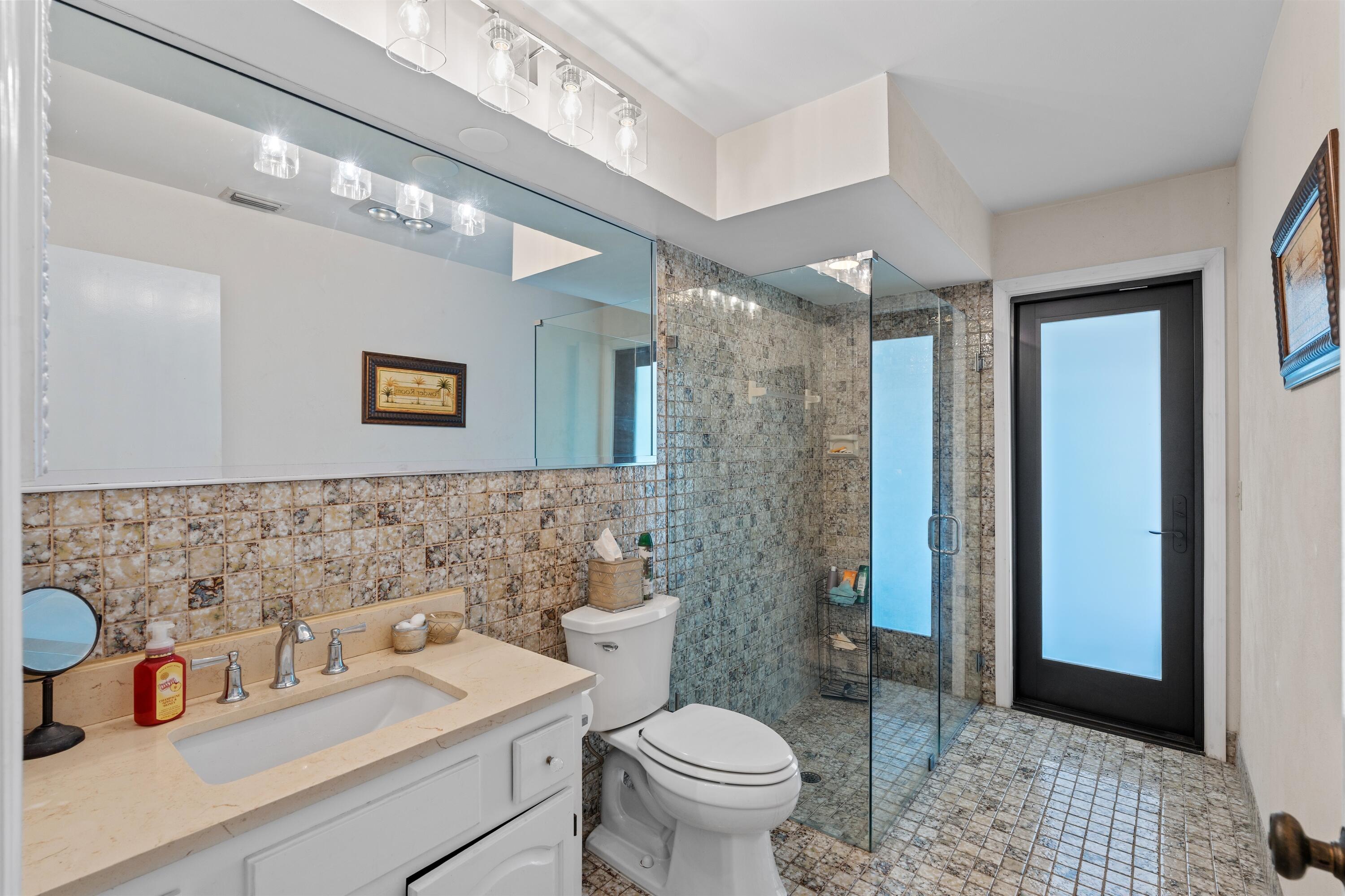 1223 Pepperridge Terrace Boca Raton, FL 33486 - Photo 21 of 34 a bathroom with a sink a toilet and shower