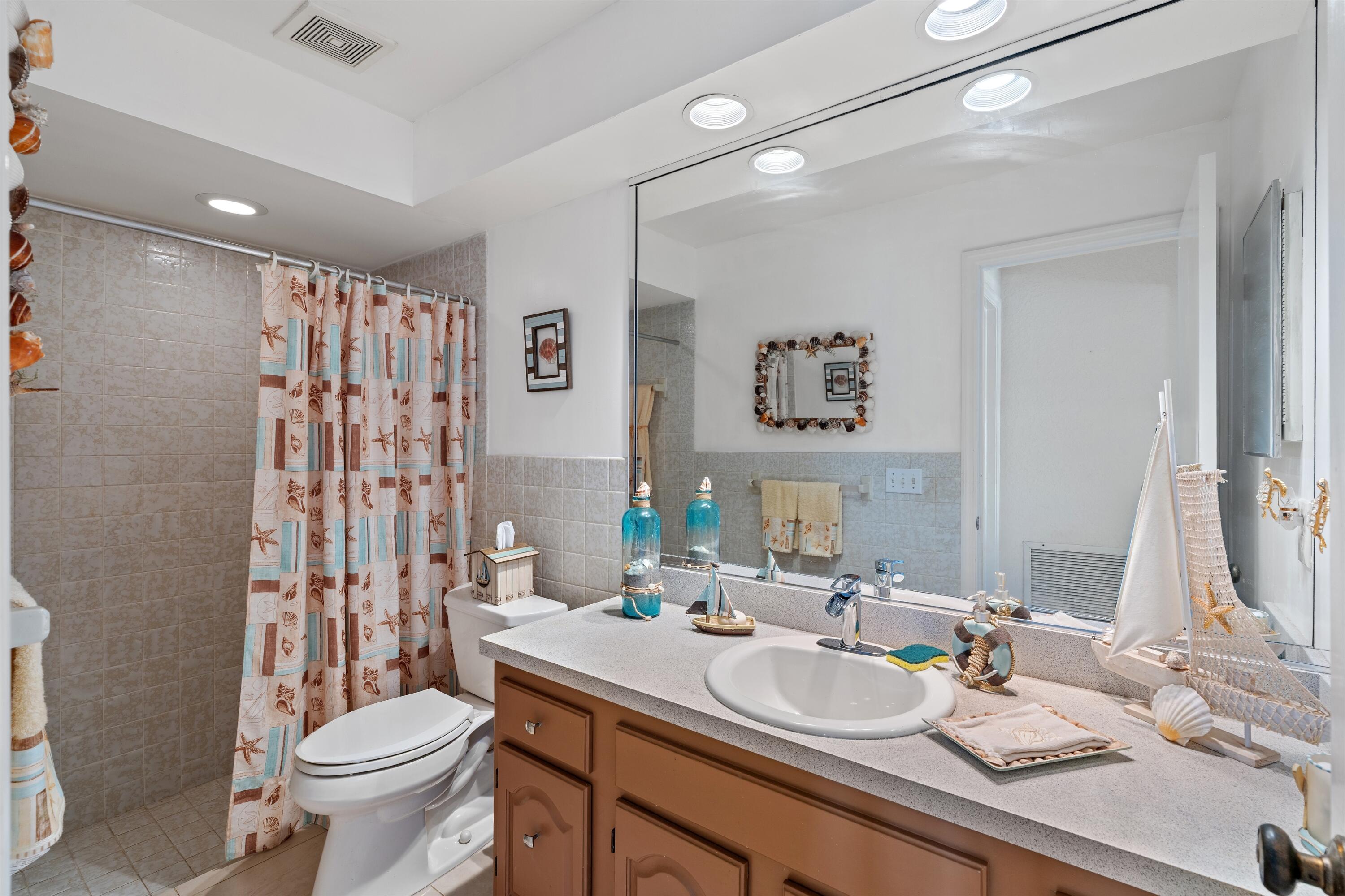 1223 Pepperridge Terrace Boca Raton, FL 33486 - Photo 25 of 34 a bathroom with a sink toilet and shower