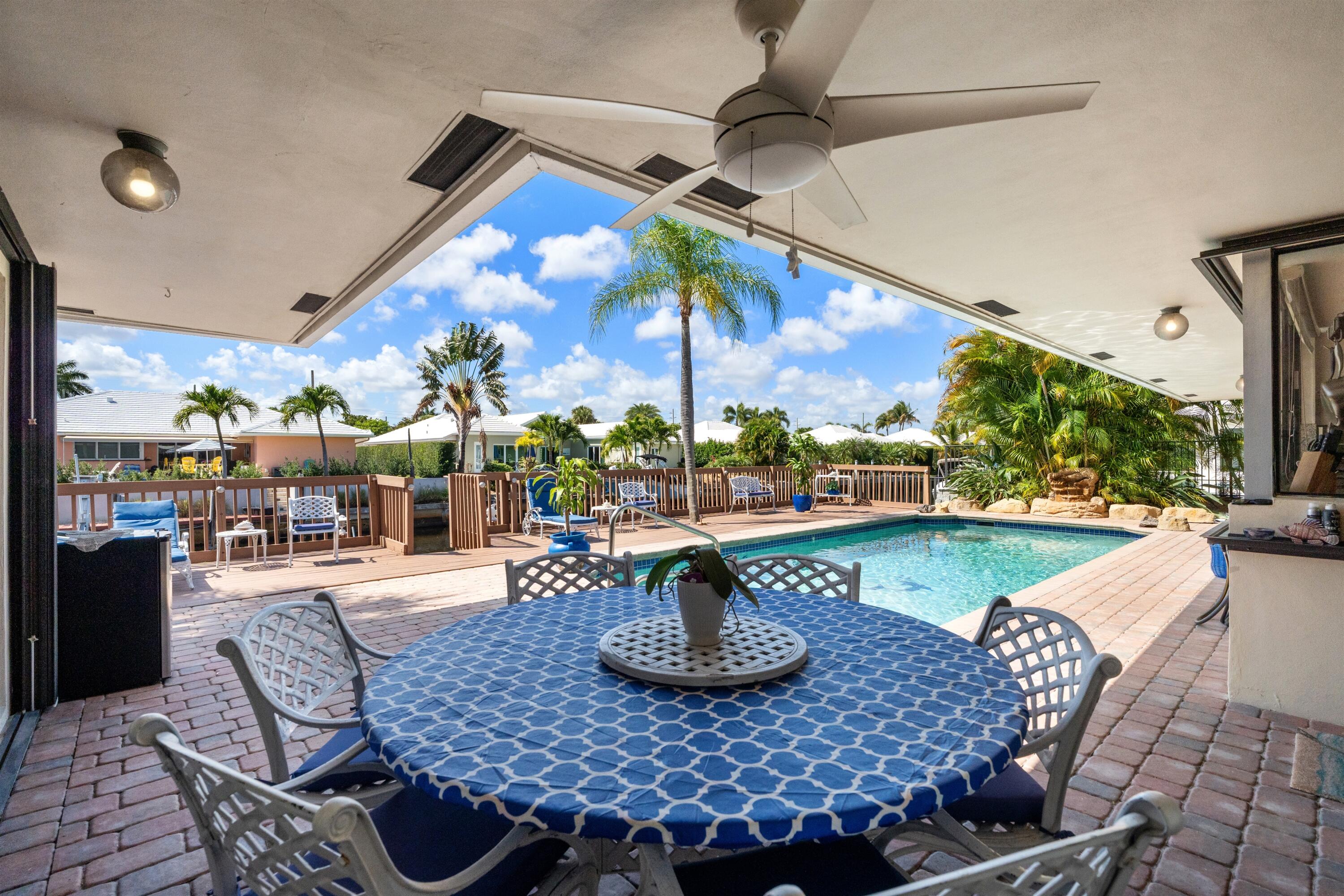 1223 Pepperridge Terrace Boca Raton, FL 33486 - Photo 26 of 34 a view of a dining room with furniture a chandelier and large window