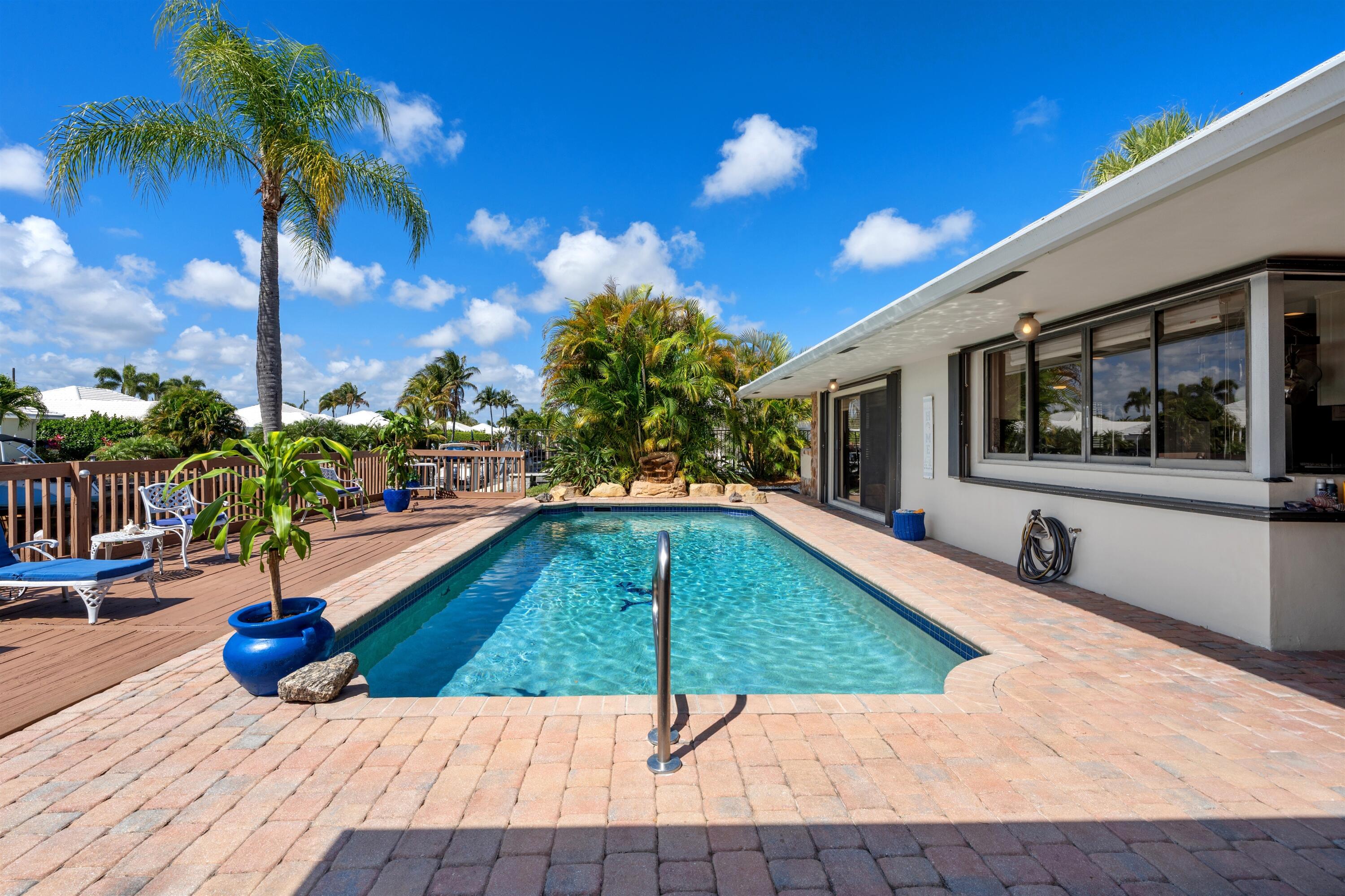 1223 Pepperridge Terrace Boca Raton, FL 33486 - Photo 28 of 34 a view of a swimming pool with a lounge chairs