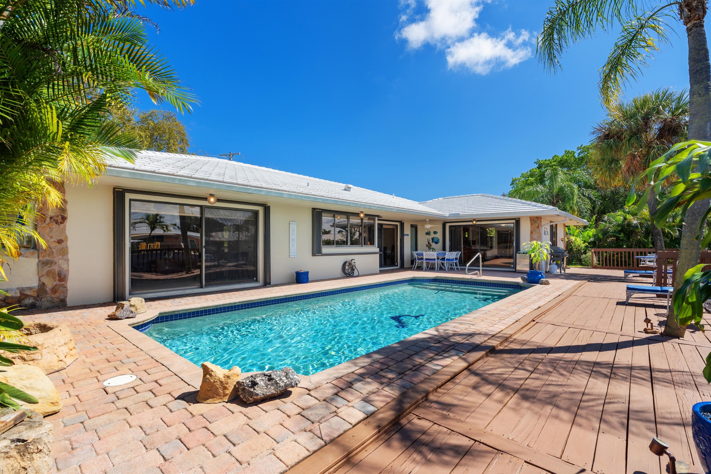 1223 Pepperridge Terrace Boca Raton, FL 33486 - Photo 30 of 34 a front view of a house with a garden and porch