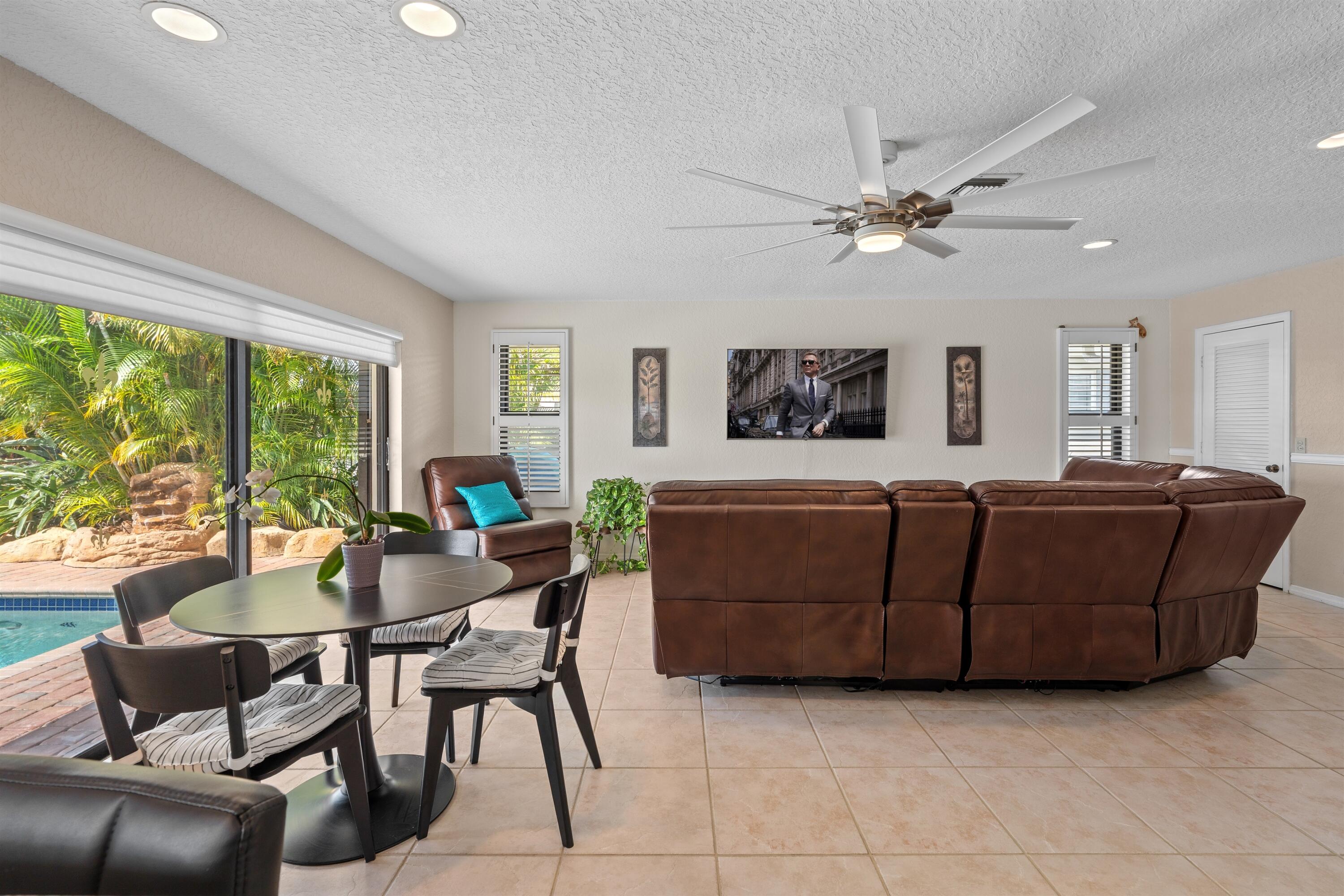 1223 Pepperridge Terrace Boca Raton, FL 33486 - Photo 6 of 34 a living room with furniture a large window and a table