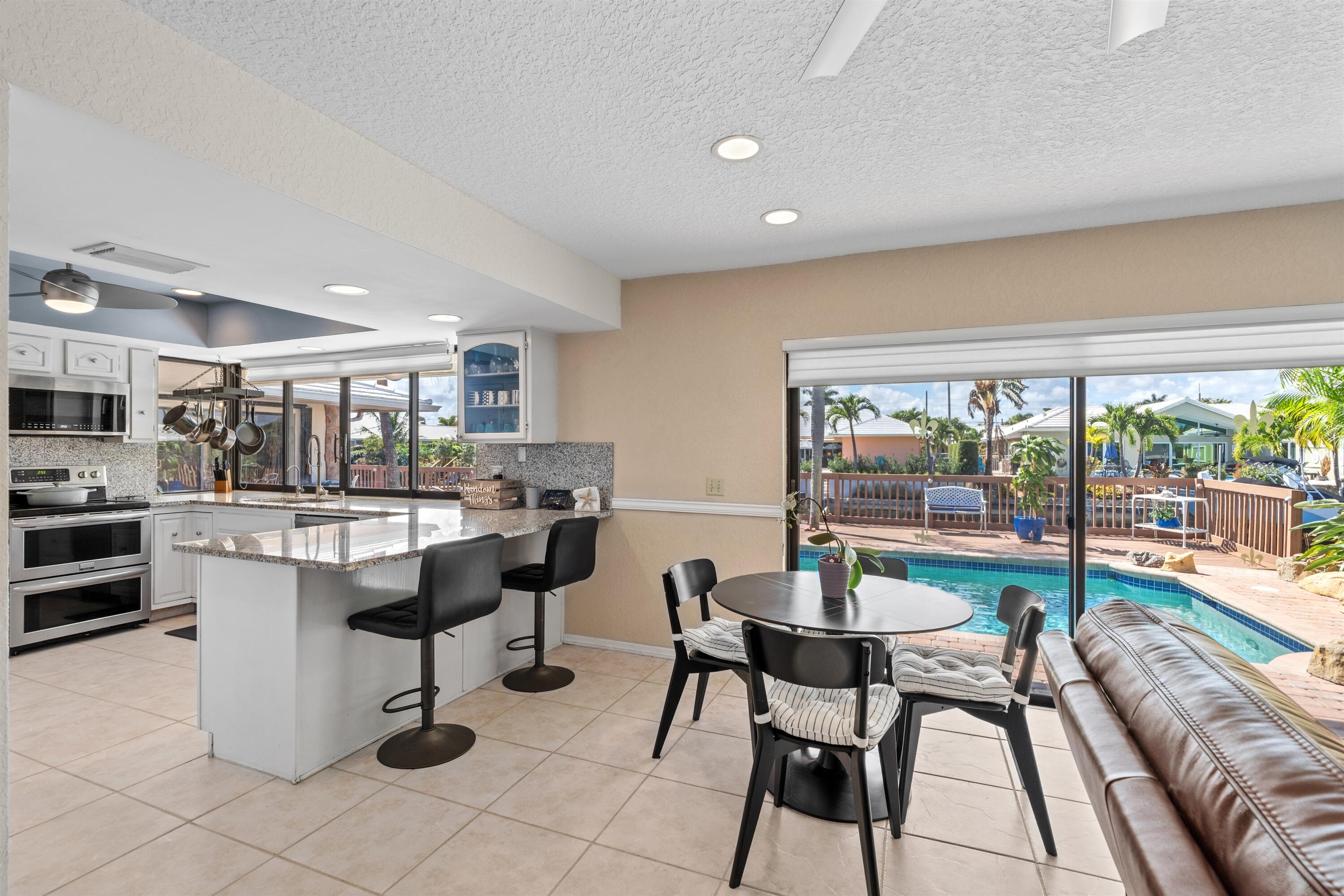 1223 Pepperridge Terrace Boca Raton, FL 33486 - Photo 7 of 34 a dining room with furniture and a floor to ceiling window