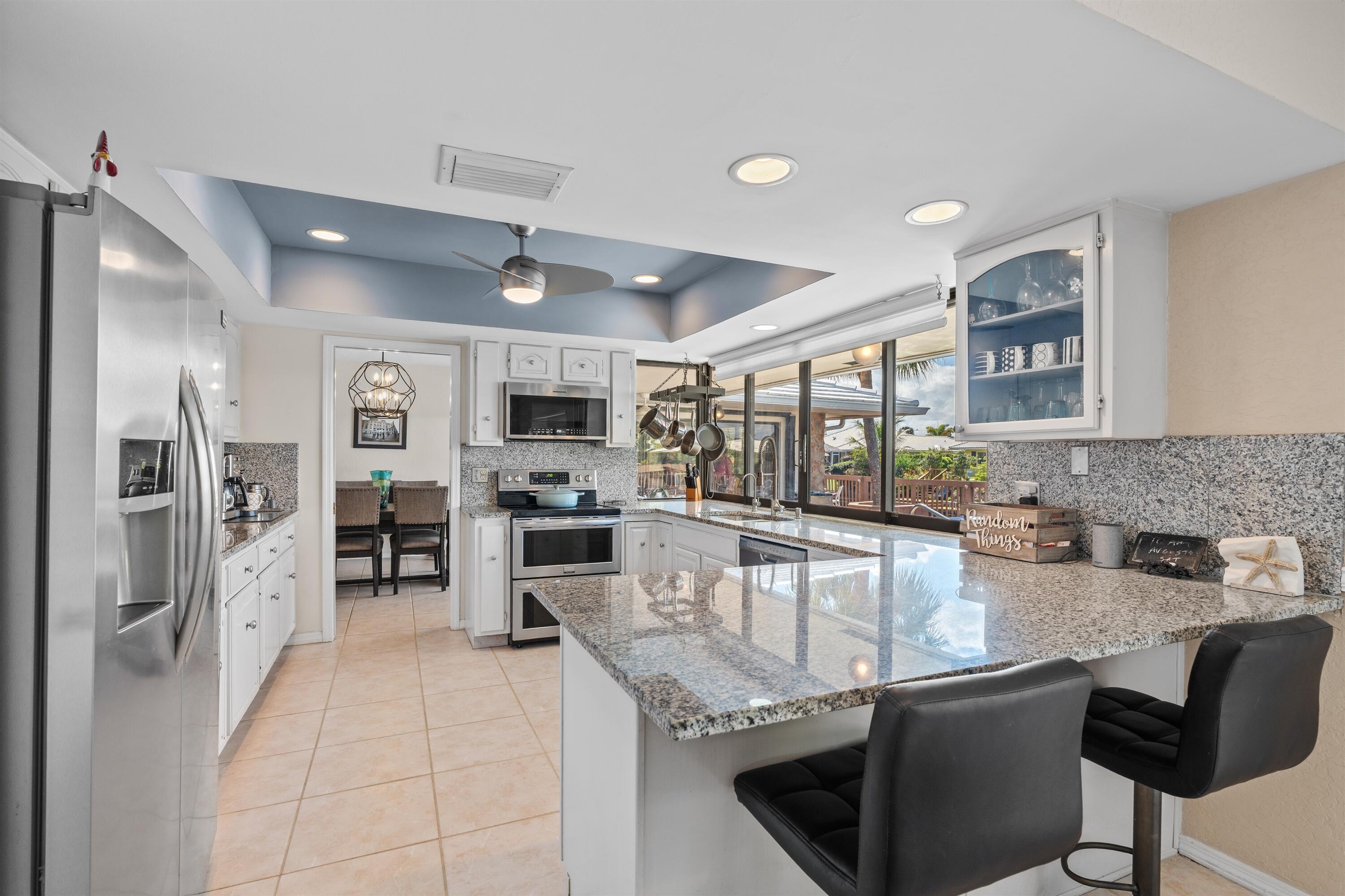 1223 Pepperridge Terrace Boca Raton, FL 33486 - Photo 8 of 34 a kitchen with stainless steel appliances granite countertop a sink stove and refrigerator