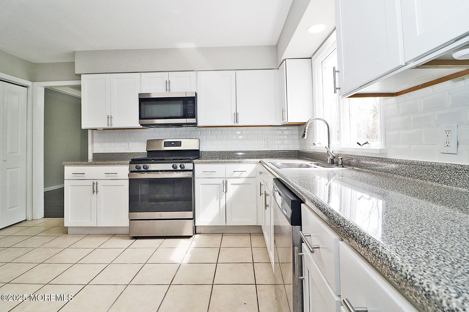 472 Steuben Avenue Forked River, NJ 08731 - Photo 23 of 50 a kitchen with granite countertop a sink a stove top oven and cabinets