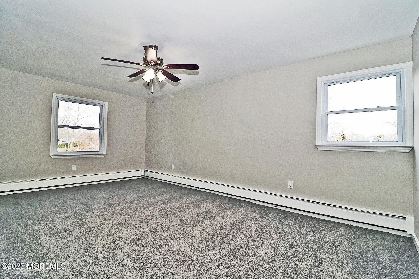 472 Steuben Avenue Forked River, NJ 08731 - Photo 36 of 50 an empty room with windows and ceiling fan