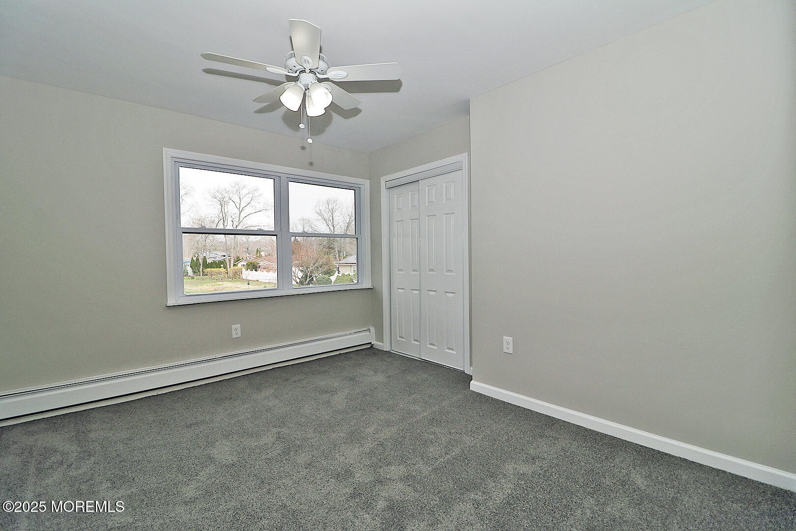 472 Steuben Avenue Forked River, NJ 08731 - Photo 49 of 50 an empty room with windows and chandelier fan