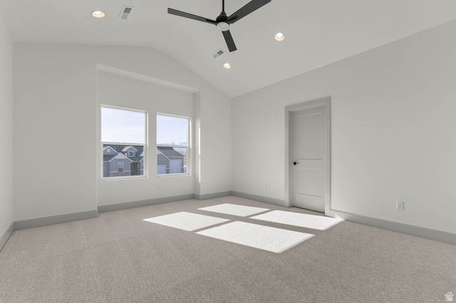 562 West Coyote Rdg Road Grantsville, UT 84029 - Photo 19 of 27 Spacious room featuring vaulted ceilings, recessed lighting, a modern ceiling fan, large windows, and neutral carpeting