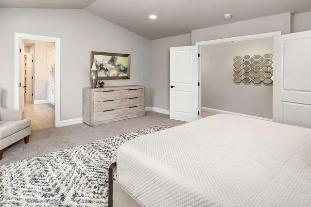 a bedroom with a bed and a couch