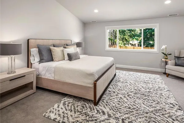 a bedroom with bed and a window