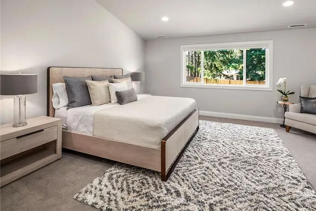 a bedroom with bed and a window