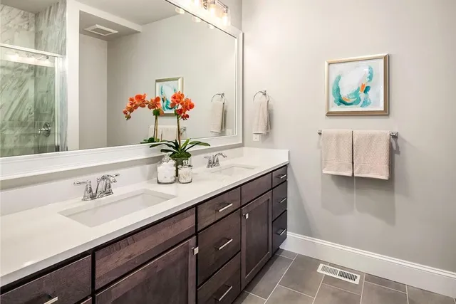 a bathroom with a sink double vanity and a mirror
