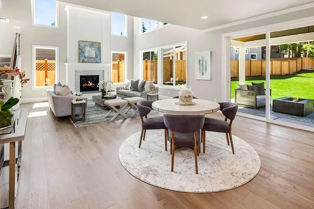 a living room with fireplace furniture and a large window