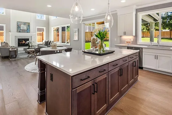 a kitchen with stainless steel appliances a sink stove and cabinets