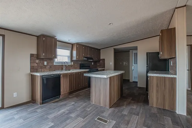 a kitchen with a sink stove and refrigerator
