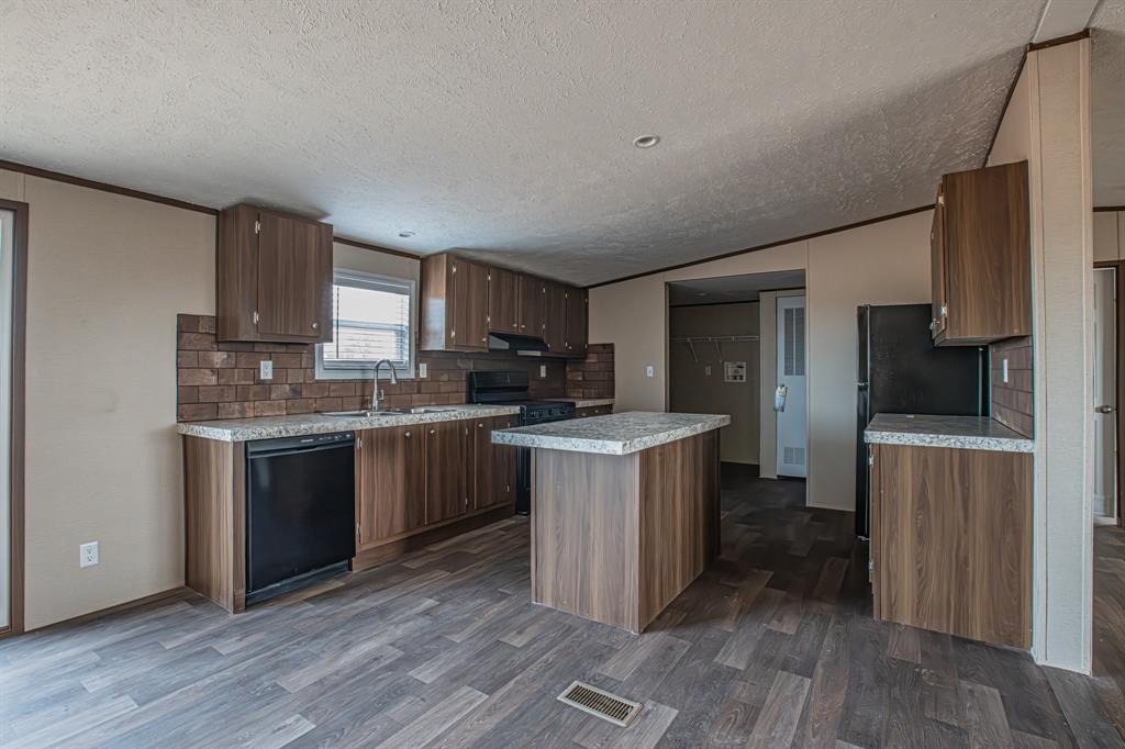 150 Leech Road Poolville, TX 76487 - Photo 11 of 34 a kitchen with a sink stove and refrigerator
