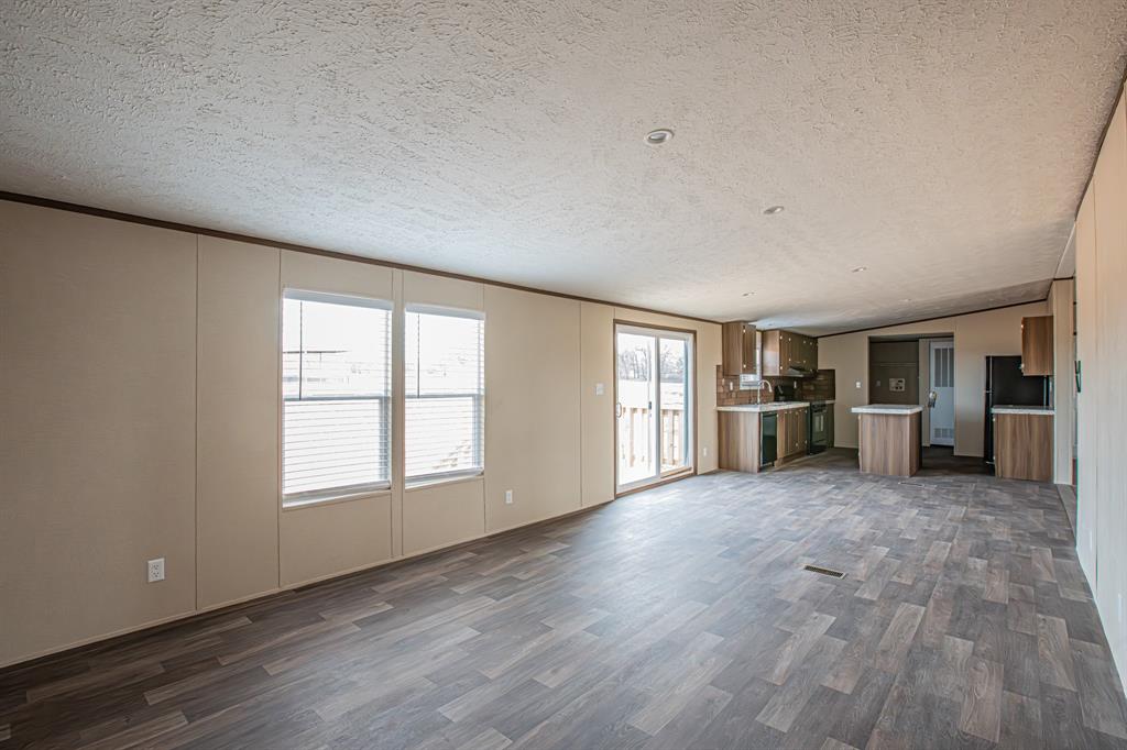 150 Leech Road Poolville, TX 76487 - Photo 12 of 34 a view of an empty room with window and cabinet