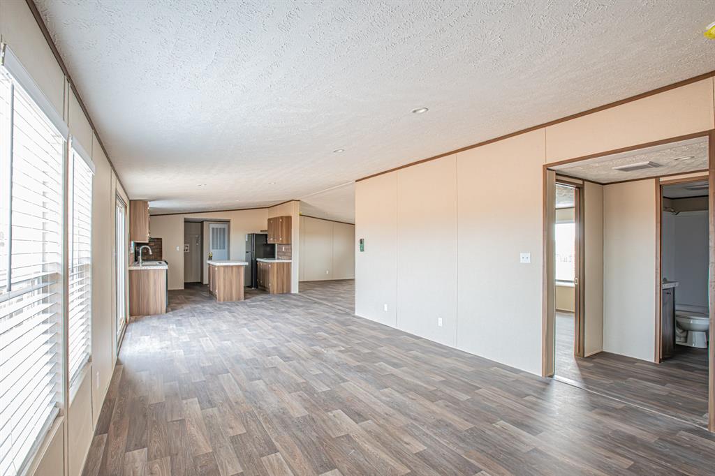 150 Leech Road Poolville, TX 76487 - Photo 13 of 34 a view of a house with wooden floor and a window