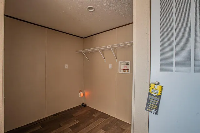 a view of storage and utility room with wooden floor