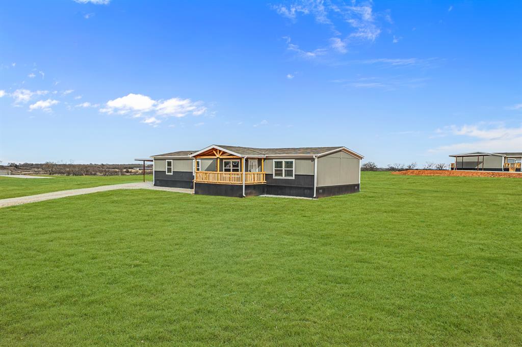 150 Leech Road Poolville, TX 76487 - Photo 3 of 34 a view of a big house with a big yard