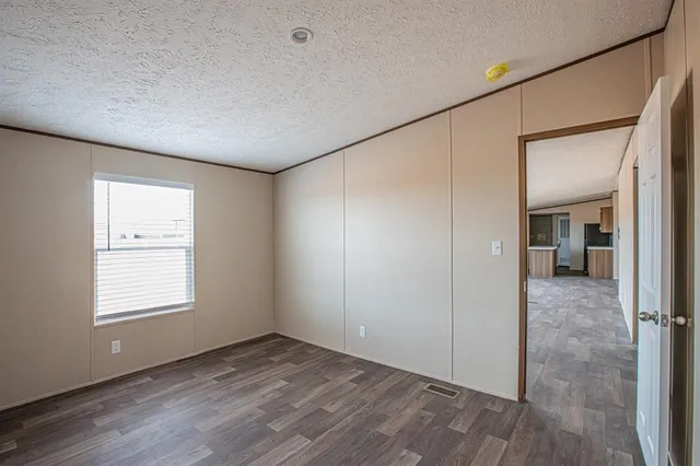 an empty room with windows and closet