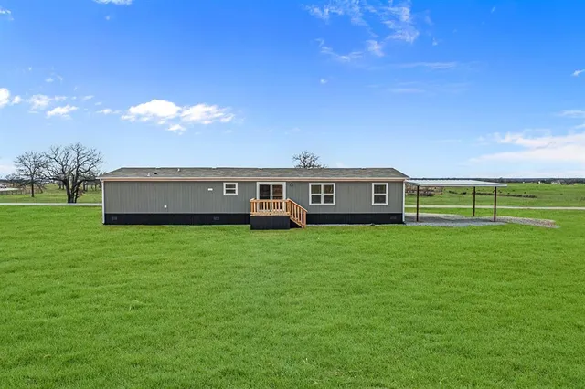 a view of a house with a big yard