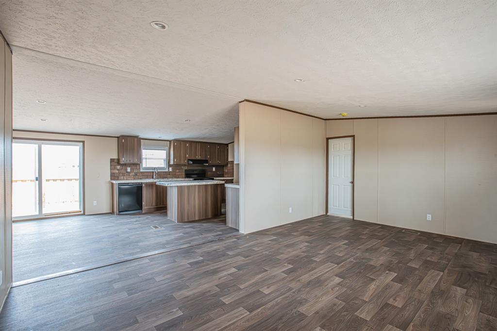 150 Leech Road Poolville, TX 76487 - Photo 7 of 34 a kitchen with stainless steel appliances a refrigerator and a stove top oven