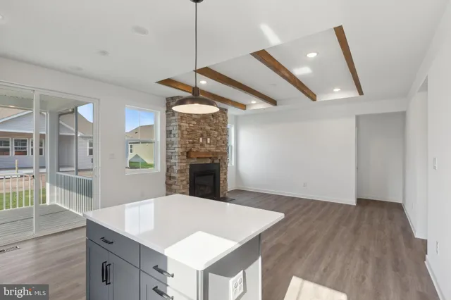 a view of a kitchen with a sink and dishwasher with wooden floor