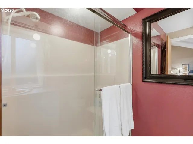 a bathroom with a shower and a mirror
