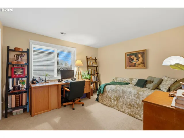 a bedroom with furniture and a window