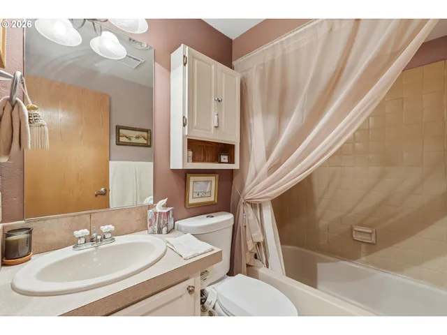 a bathroom with a sink a mirror and a shower curtain
