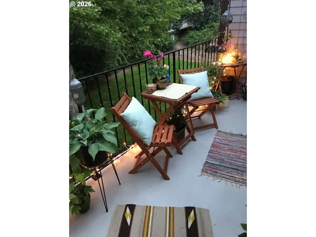 a balcony with table and chairs