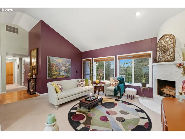 a living room with furniture a rug and a fireplace
