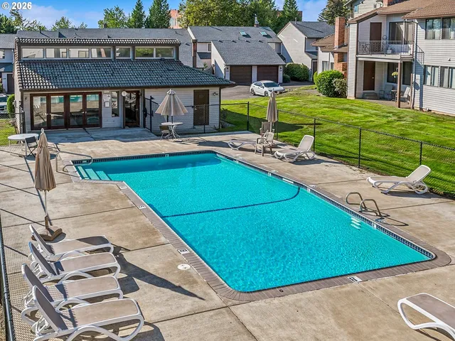 a view of a patio with a table and chairs