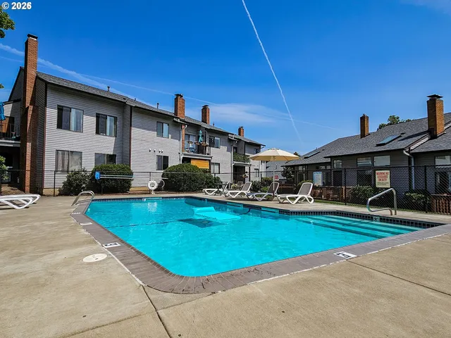 a view of an house with swimming pool and sitting area