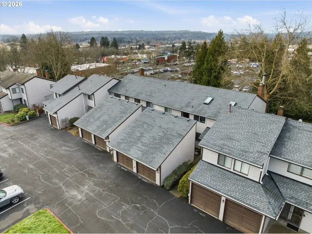 an aerial view of a house with garden space and street view