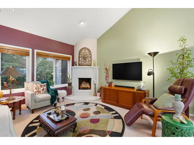 a living room with furniture a flat screen tv and a fireplace