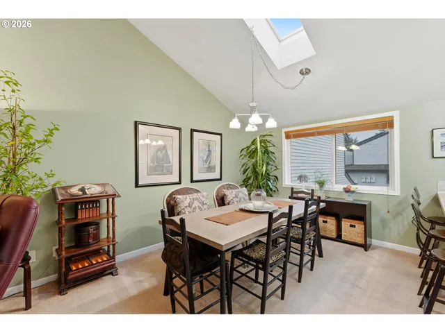 a view of a dining room with furniture and chandelier