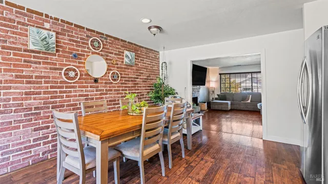 a dining room with furniture and wooden floor