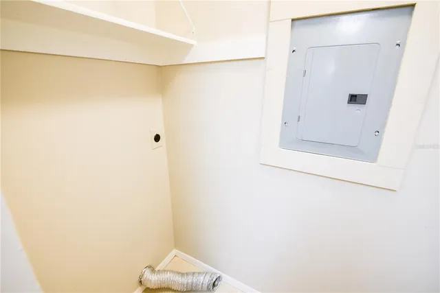 a view of an empty room with window and bathroom