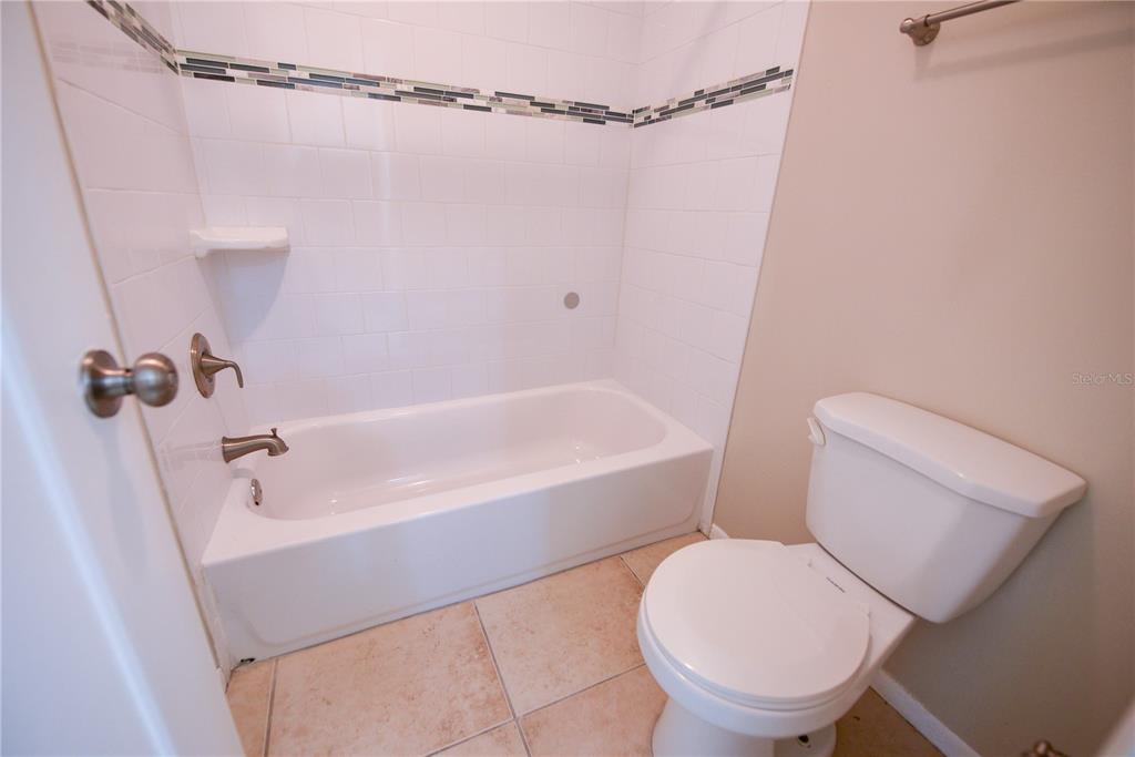 455 Alt 19, Unit 92 Palm Harbor, FL 34683 - Photo 9 of 19 a white toilet sitting next to a bath tub