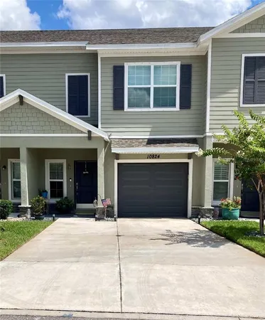 a front view of a house with a yard and a garage