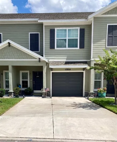 a front view of a house with a yard and a garage