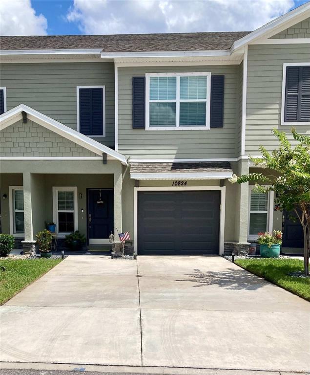a front view of a house with a yard and a garage