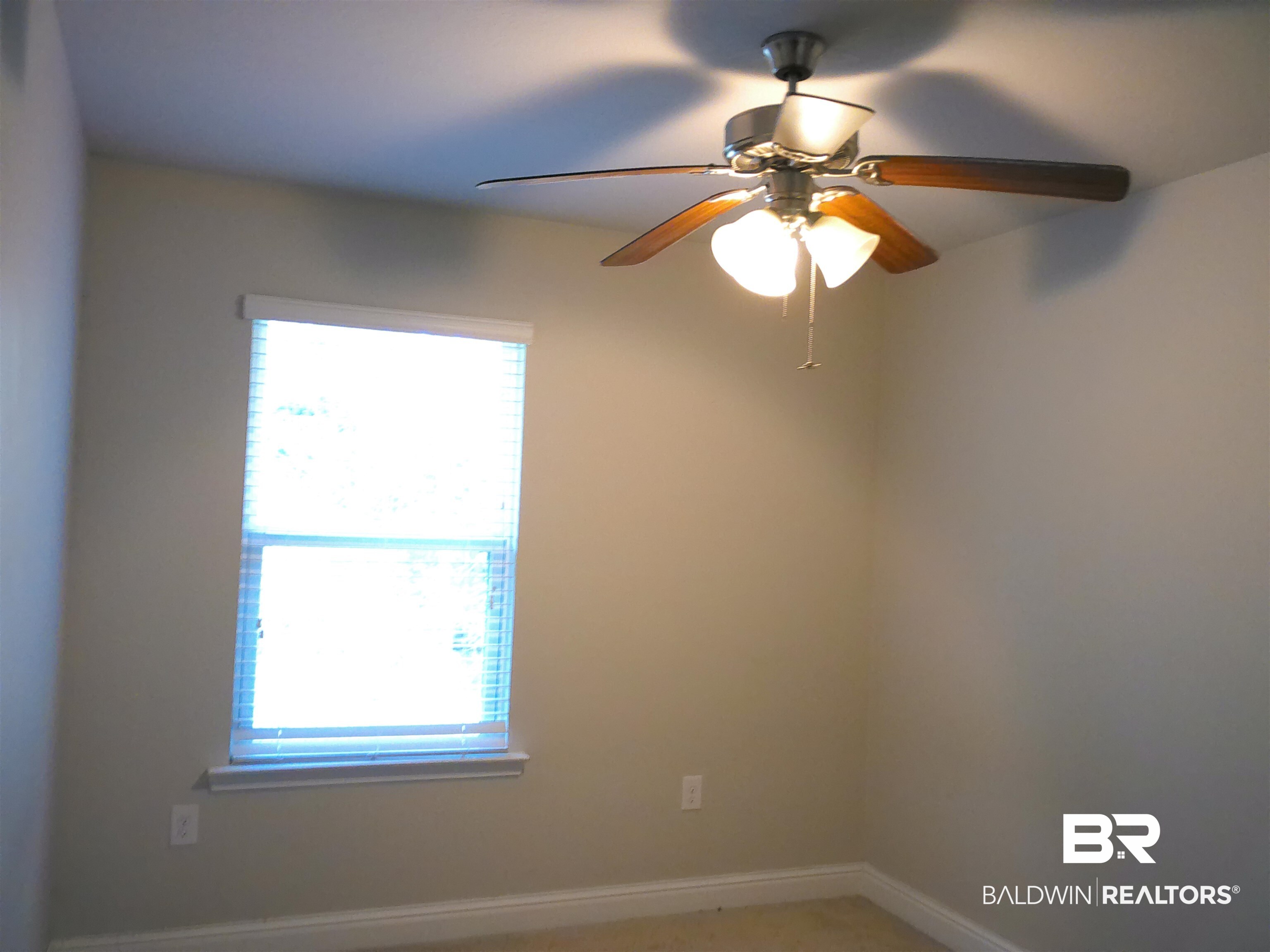 25806 Pollard Road, Unit 23 Daphne, AL 36526 - Photo 7 of 16 Spare room with baseboards and a ceiling fan