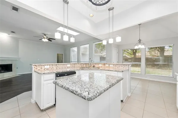 a bathroom with a granite countertop sink a large mirror and a shower