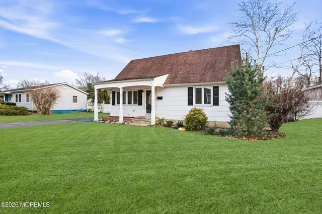 a front view of house with yard and green space
