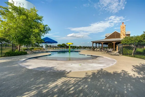 a swimming pool with outdoor seating and yard